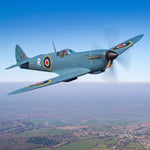 Spitfire aircraft banking over the English countryside