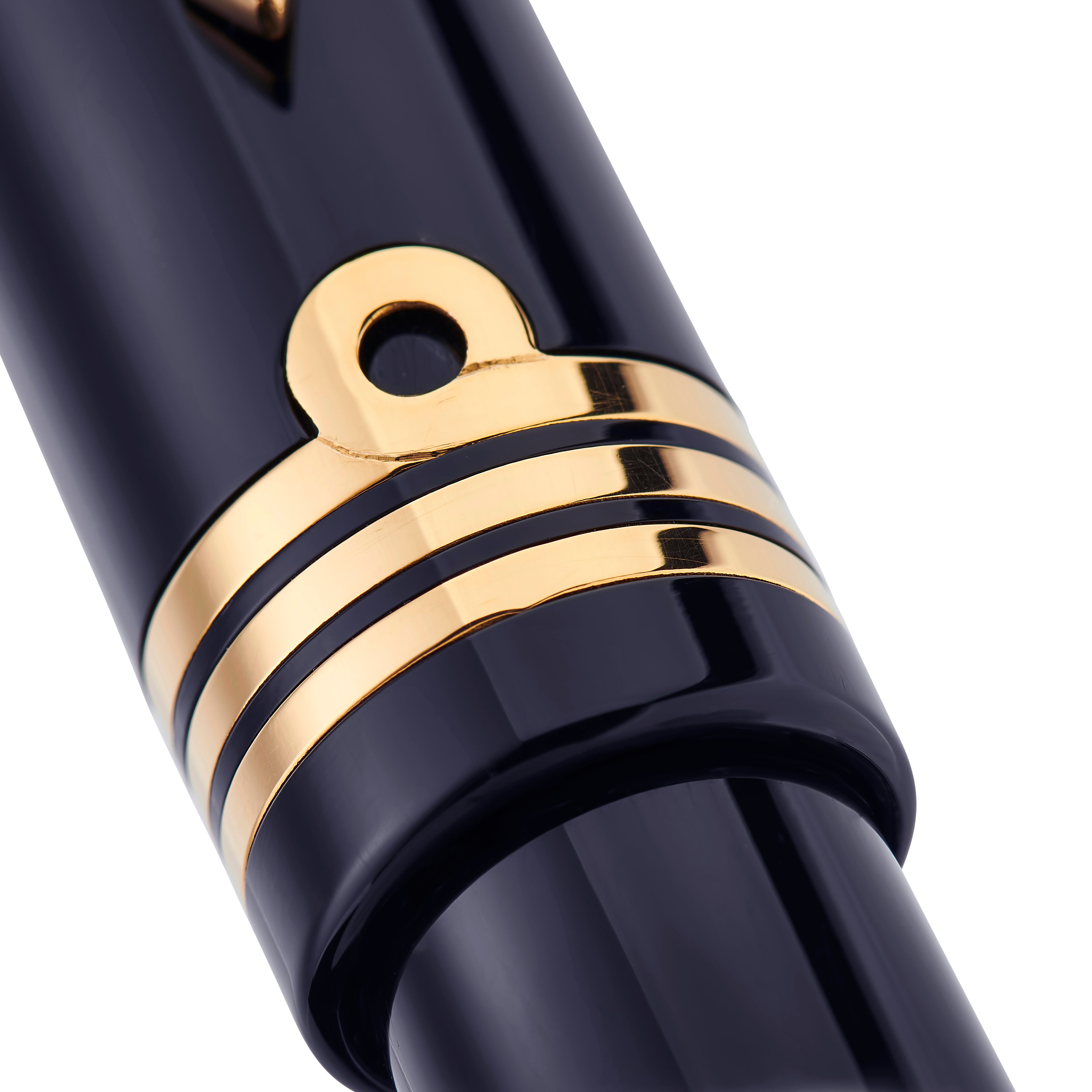 Series 100 Commander rollerball capped, resting on green fabric with gold commander rings visible