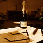 The Pol Roger pen capped on a desk beside a bottle of Pol Roger champagne